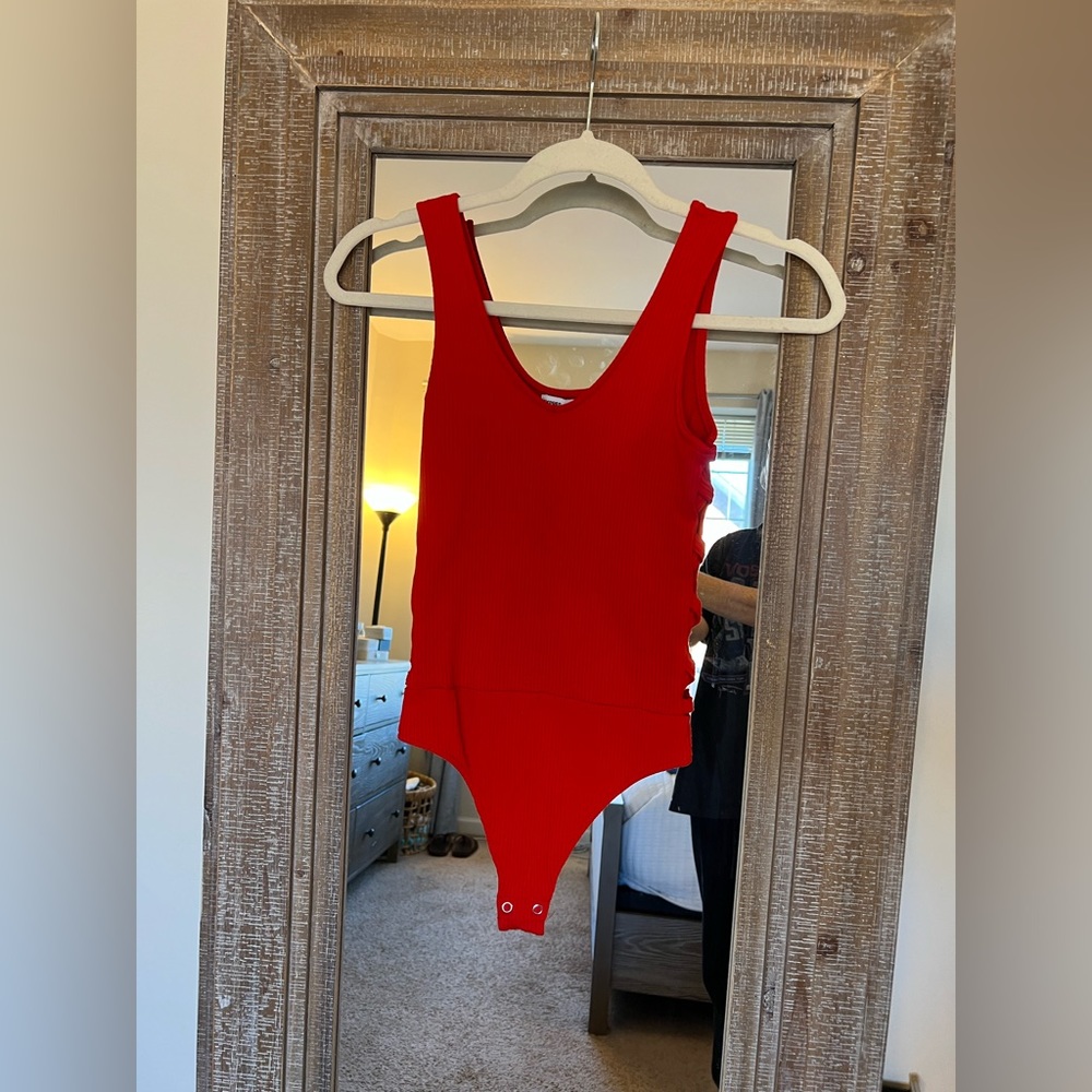 Red bodysuit with cut outs on sides. Size XS.